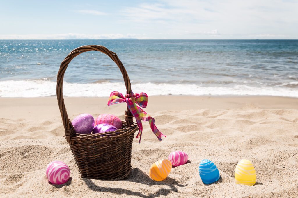 Easter,Basket,With,Color,Eggs,On,The,Sandy,Beach,Near